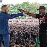 Mayweather and McGregor on stage pointing