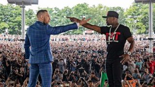 Mayweather and McGregor on stage pointing
